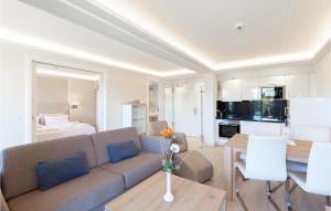 a living room with a couch and a dining room at Prince in Binz