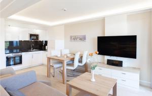 a living room with a dining room table and a kitchen at Prince in Binz