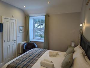 a bedroom with a large bed with a window at Cartref Guesthouse - Room 2 Ensuite in Aberdyfi
