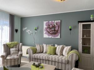 a living room with a couch and two chairs at Ferienhaus DolceVita in Walkenried