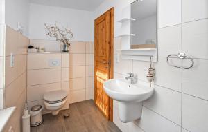 a white bathroom with a sink and a toilet at Ferienhaus Kummerow in Kummerow +7 photos