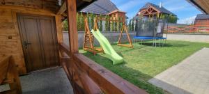 a yard with a playground with a slide at Chata Alex in Stará Lesná