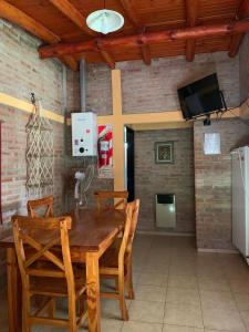 a dining room with a wooden table and chairs at INTI MAYU Cabañas in Mina Clavero