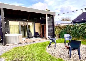 a group of chairs sitting in a yard at Family house with garden & jacuzzi & sauna near Amsterdam in Vijfhuizen
