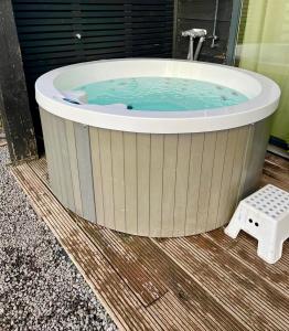 a jacuzzi tub sitting on a wooden floor at Family house with garden & jacuzzi & sauna near Amsterdam in Vijfhuizen