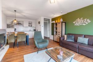 a living room with a couch and a table at Appartementencomplex Juliana 166 in De Koog