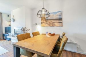 a dining room with a wooden table and chairs at Appartementencomplex Juliana 166 in De Koog +3 photos