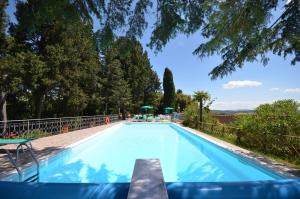 a swimming pool with trees in the background at Tenuta di Casaglia in Podere Colombaie