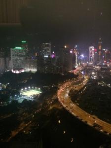 a night view of a city with traffic on a highway at Twenty One Whitfield in Hong Kong