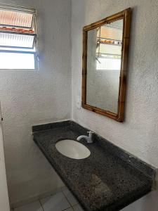 a bathroom with a sink and a mirror at Pousada Éden Rio in Ilhéus +31 photos