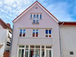 a white house with a window at Business-Apartments im SCHUSTER-ACHT in Wolgast