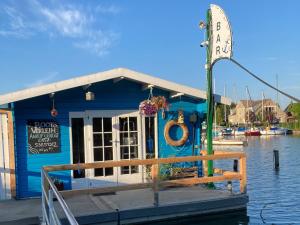 a restaurant on a dock on a body of water at Business-Apartments im SCHUSTER-ACHT in Wolgast