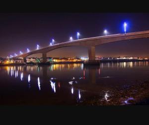 a bridge over a body of water at night at Southampton Central Pad in Southampton +1 photo