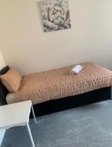 a bed with a stuffed animal on it in a room at Southampton Central Pad in Southampton