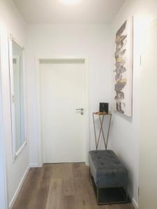 a white room with a white door and a bench at Dom 007 in Fulda +2 photos