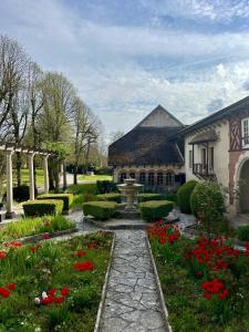 a house with a garden with flowers in front of it at Le Prieuré de Buffon in Buffon +9 photos