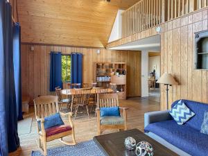 a living room with a blue couch and a table at Cabin w hot tub & fire pit near Cacapon in Berkeley Springs