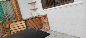 a bench sitting next to a sink and a ladder at Little Susie Family Room in Phnom Penh