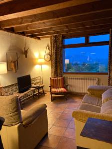 a living room with a couch and a tv at Casa Azul Rodiles in Selorio