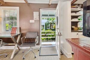 an office with a desk and a chair and a window at 16 E Jones Carriage House in Savannah