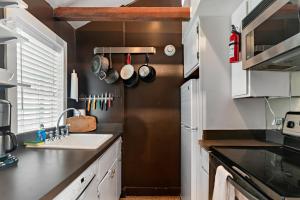 a kitchen with a sink and a counter top at 16 E Jones Carriage House in Savannah +44 photos