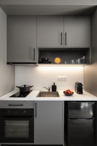a kitchen with a sink and a stove at Fits Living in Athens +53 photos