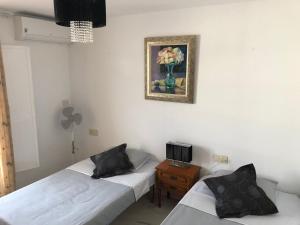a room with two beds and a picture on the wall at 2 Bedroom Townhouse - Mojacar - sleeps 4 - R018 in Mojácar
