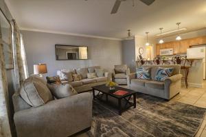 a living room with two couches and a table at 305 W Taylor Garden in Savannah