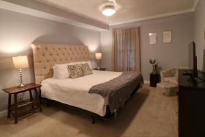 a bedroom with a large bed and a window at 305 W Taylor Garden in Savannah