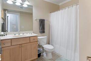 a bathroom with a toilet and a sink and a shower at 305 W Taylor Garden in Savannah +43 photos