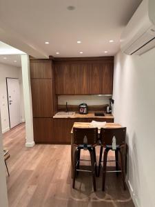 a kitchen with a table and two chairs in a room at R&DLux in Durrës +31 photos