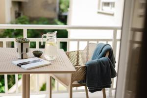 a glass bottle on a table on a balcony at R&b Living Experience in Alexandroupoli