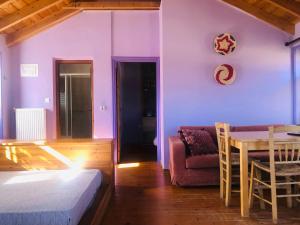 a room with a bed and a table and a couch at Guesthouse Kontogianni - Materka in Nymfaio