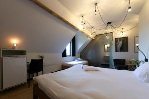 Una cama o camas en una habitación de 't Convent