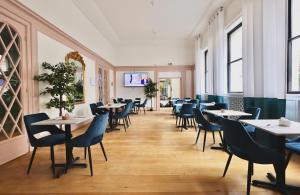 a dining room with tables and chairs at Hotel de la Bourse, Mulhouse Gare, Sure Hotel Collection by Best Western in Mulhouse