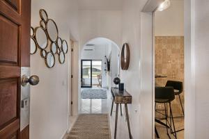 a hallway with a table and a chair in a room at 212 Aurora sol - CASINHA DO SOL in Praia do Carvoeiro +21 photos