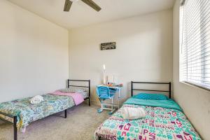 a room with two beds and a table in it at 8 Mi to Lincoln Park Family-Friendly Tracy Home in Tracy