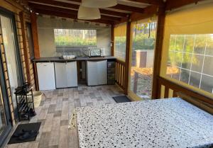 an inside view of a kitchen in a tiny house at Location Mobilhome Bahiana 8 personnes Camping 4 étoiles La Réserve Gastes in Gastes +2 photos