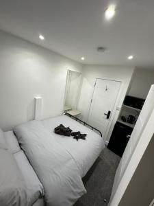 a bedroom with a large white bed and a door at London Euston 4 minute walk away in London