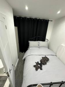 a bedroom with a bed with a black headboard at London Euston 4 minute walk away in London