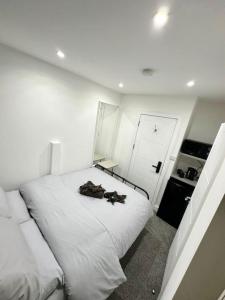 a bedroom with a white bed with a robe on it at London Euston 4 minute walk away in London