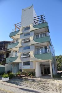 a tall building with balconies on the side of it at Villa Maciel Bombinhas in Bombinhas
