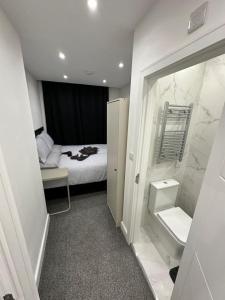 a small room with a bed and a bathroom at Near London Soho and Oxford Circus in London