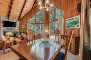 a dining room with a table and a living room at Arnold Chalet Near Town and Calaveras Big Trees! in Arnold