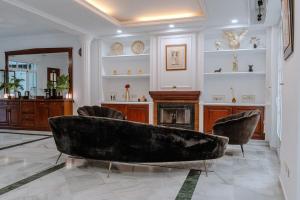 a living room with a couch and a fireplace at El Mirador De La Consentida Rooms & Suites Boutique in Marbella