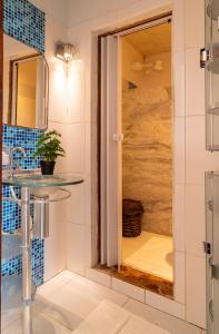 a bathroom with a shower with a glass door at Pousada Coral Negro in Jericoacoara +113 photos