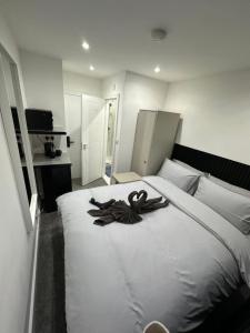 a bedroom with a large white bed with a scarf on it at Central London Zone 1 Room wbath in London