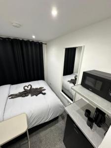 a hotel room with two beds and a television at Central London Zone 1 Room wbath in London