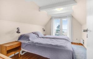 a white bedroom with a bed and a window at Cozy Home In Glesborg With Kitchen in Glesborg