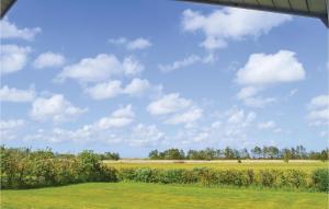 a field of grass with a blue sky with clouds at Holiday Home Kuskevej Jerup in Jerup